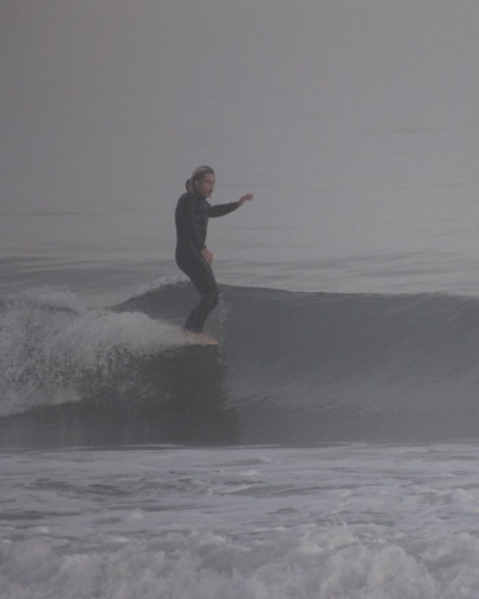 Evan surfing on a foggy day